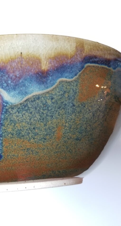 A close up of the bowl with blue and brown colors.