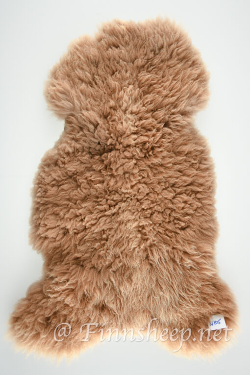 A brown sheepskin rug on top of white background.