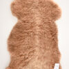 A brown bear rug with white tag on it.